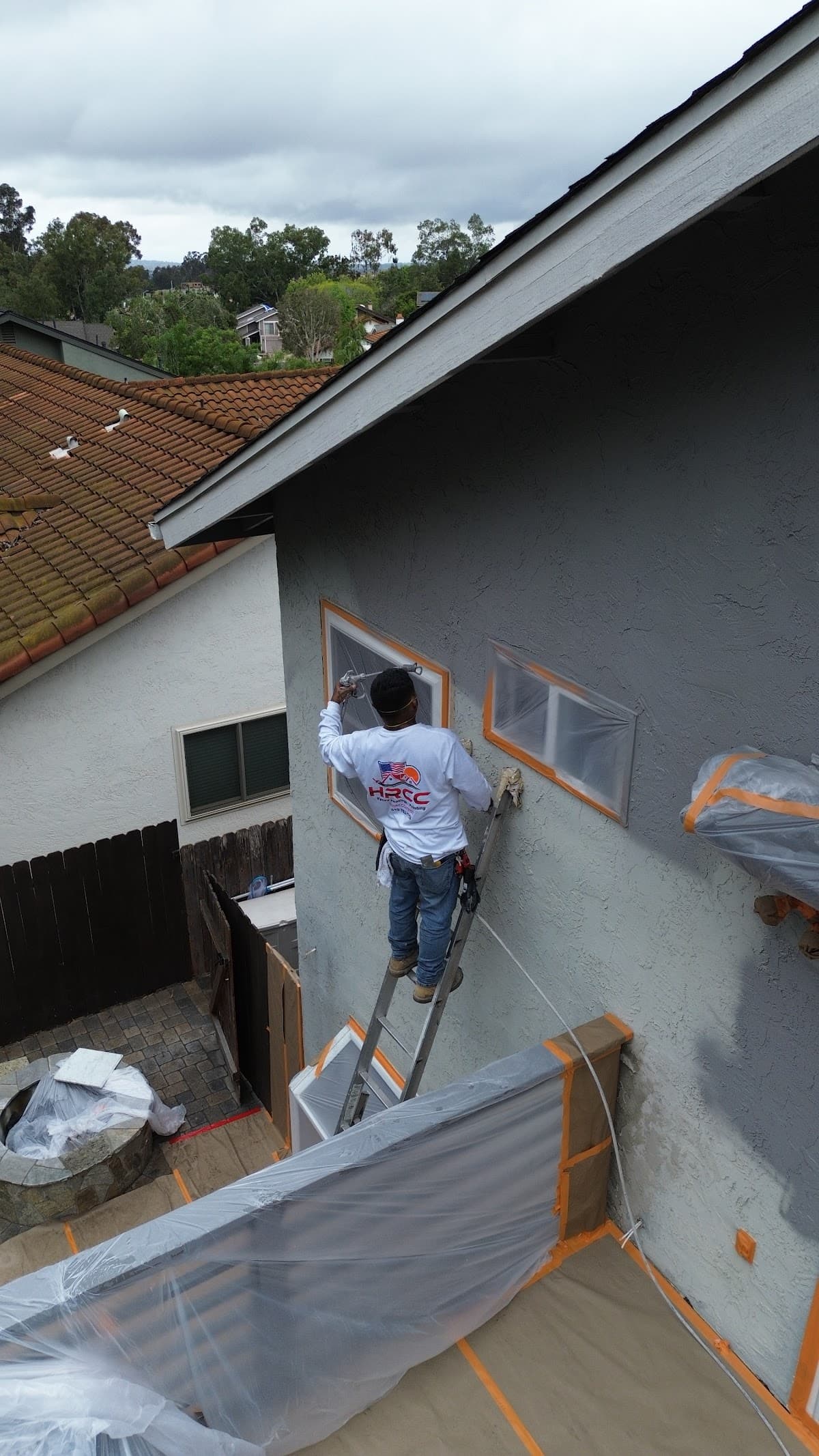 Our crew on the job, spraying a home exterior